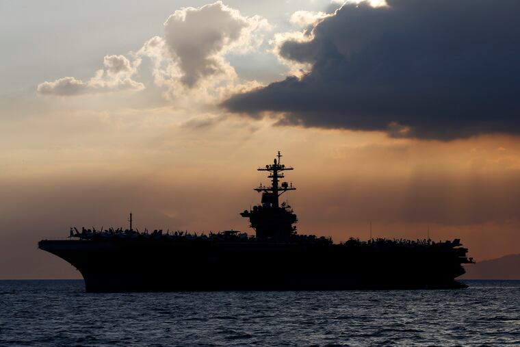In this 2018 photo, the USS Theodore Roosevelt is anchored off Manila Bay west of Manila, Philippines.