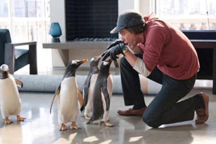 Jim Carrey as Tom Popper with his Antarctic arrivals. Popper is an obsessed executive whose life is changed by the penguins.