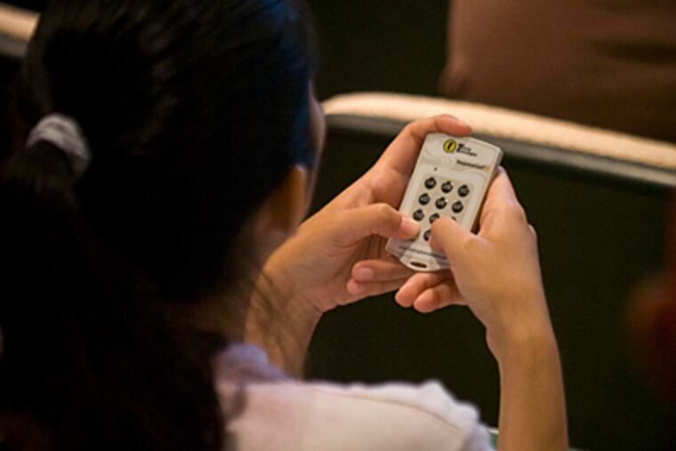 A Temple student uses a clicker to submit an answer in Samuel D. Hodge Jr.'s class. He started using them, he said, to capture students' attention. (Ron Tarver/Staff)