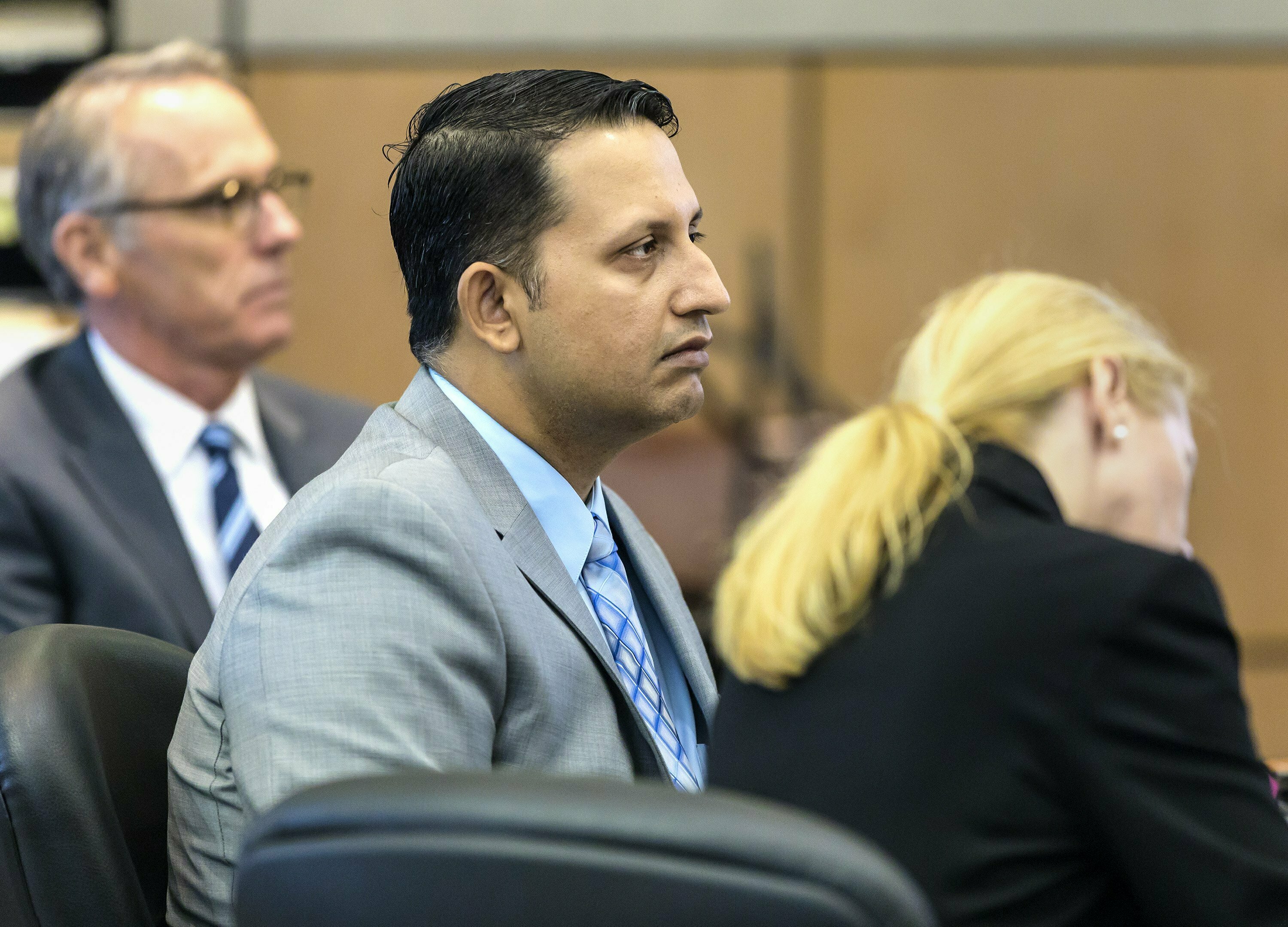 Nouman Raja sits between defense attorney Scott Richardson (left) and paralegal Debi Stratton as attorney Richard Lubin gives his closing arguments in Raja's trial on Wednesday.