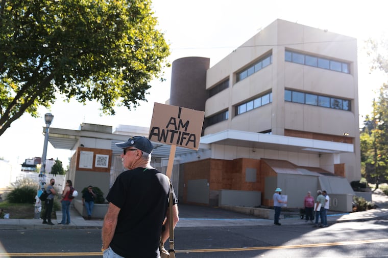 Demonstrators protest outside a U.S. Immigration and Customs Enforcement facility in Portland, Ore., on Sunday.