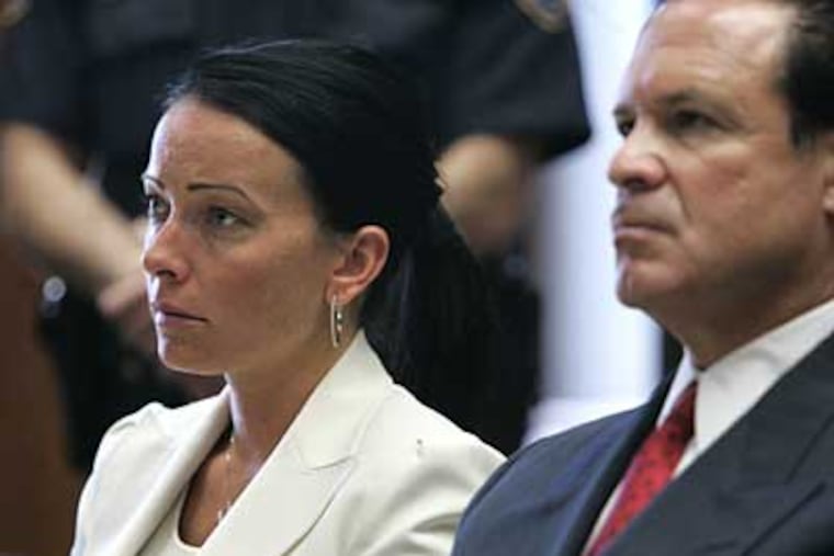 Heather DiCarlo, center, a former New Jersey beauty pageant winner, next to her attorney, Paul Bergrin, as she is sentenced in Superior Court for bouncing more than $70,000 in bad checks. (AP Photo/Mike Derer, Pool)