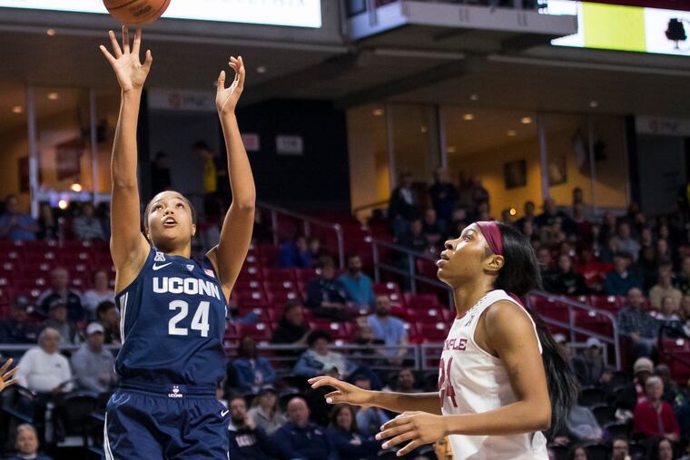 Connecticut's Napheesa Collier shoots the ball as Temple's Shantay Taylor (right) watches.