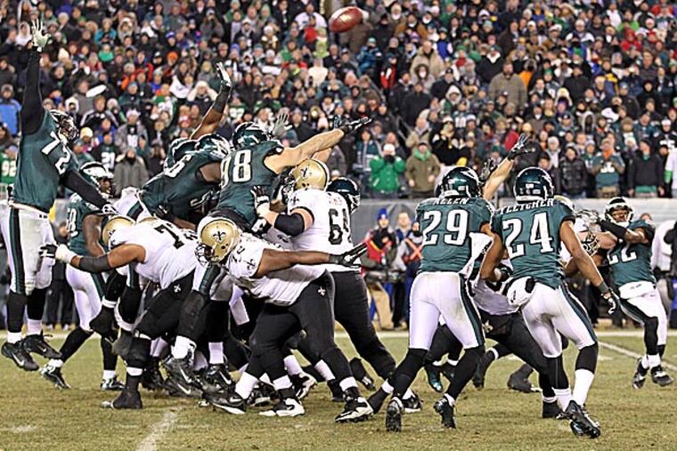 Eagles special team members try to block the Saints' game-winning field goal attempt as fans watch. (Yong Kim/Staff Photographer)