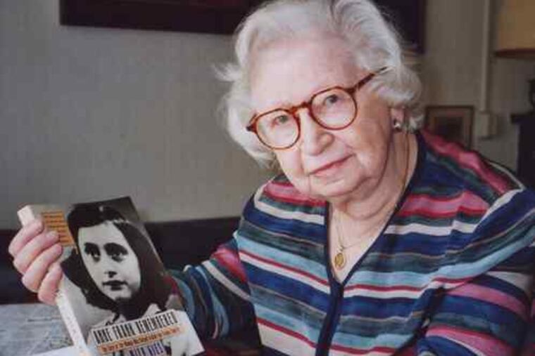 Miep Gies, at her Amsterdam apartment in 1998, displaying her book about Anne Frank. A new edition is coming out this year.