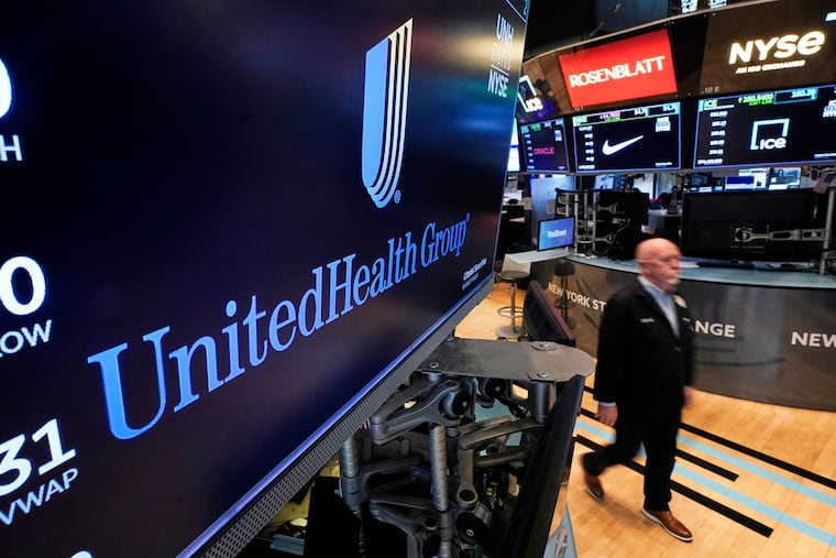 The logo for UnitedHealth Group appears above a trading post on the floor of the New York Stock Exchange in April 2025.
