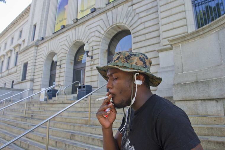 RRXSMOKE12 -- 8/11/16 -- Community College of Philadelphia student Omar Montigue of North Philadelphia has a smoke outside the school's main building along Spring Garden Street. The college will be instituting a school wide ban on smoking throughout the entire campus. (Avi Steinhardt/ For the Philadelphia Inquirer)