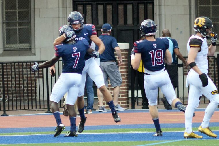 Penn's Christian Pearson (7) and Justin Watson (5) celebrate a touchdown Sept. 16