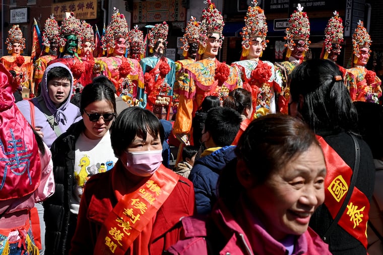 Figures representing the gods are out on the street as the Hoyu Folk Cultural Festival is celebrated in Chinatown, Sunday Mar. 26, 2023.
