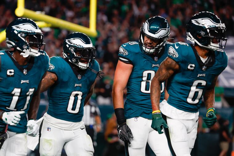 Philadelphia Eagles running back D'Andre Swift (0) celebrates a fourth quarter touchdown against the Vikings with teammates A.J. Brown (11), tight end Dallas Goedert (88), and wide receiver DeVonta Smith (6).