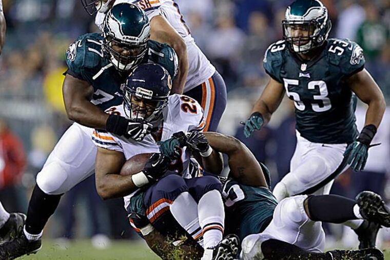The Eagles defense tackles Bears running back Michael Bush. (Michael Perez/AP)