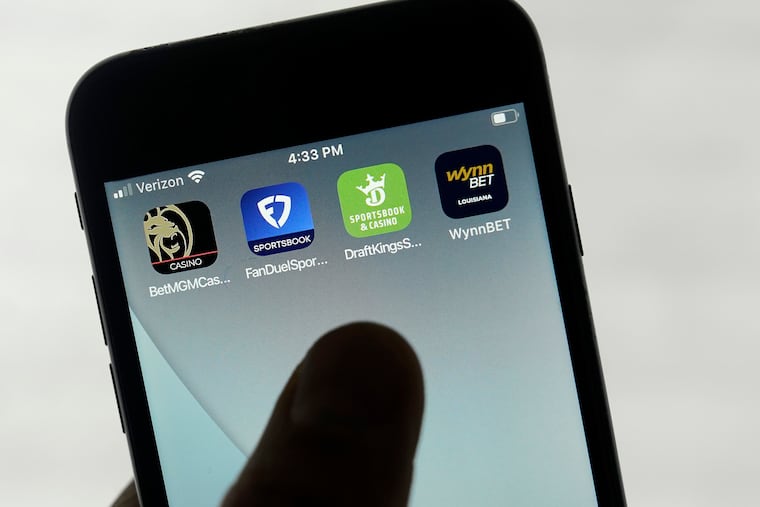 FanDuel, DraftKings, and other online gambling apps are displayed on a phone in 2022.