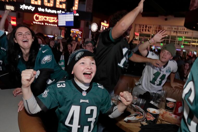 Eagles fans celebrate an Eagle touchdown, while watching the game, at XFINITY Live! Philadelphia in South Phila., Pa. on December 29, 2019. The Eagles defeated the Giants 34-17.