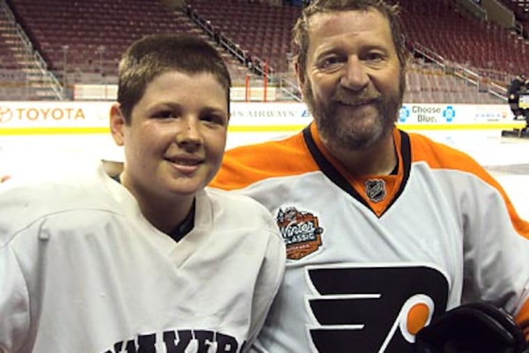 Peter Luukko with his son, Max. (Photo courtesy Comcast-Spectacor.)