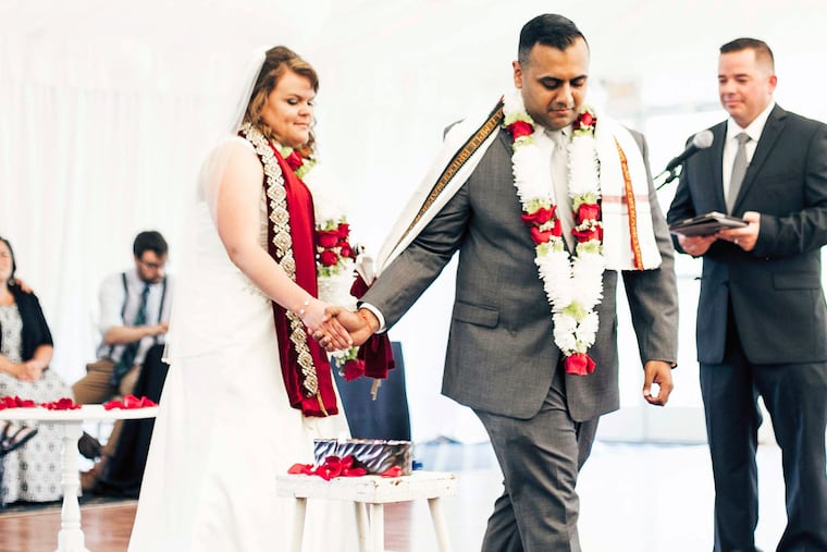 Emily Leonard and Aalok Joshi. They couldn't have a fire pit, so Emily and Aalok lit a candle for the "saptapadi," circling it seven times as the pastor asked God to bless them and their families.