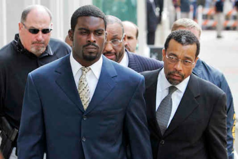 Michael Vick heading to court in Richmond, Va., with his lawyer, Billy Martin (right), to face dog-fighting charges in 2007. He eventually served 23 months in prison. In the BET pilot, he describes his behavior as "inhumane and barbaric."