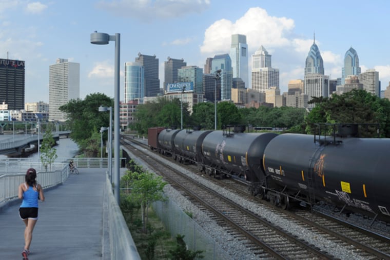 Slow-moving, mile-long crude oil trains are hard to hide, but a shroud of secrecy cloaks their movements, the condition of their infrastructure, and the planned safety responses if something goes wrong. Oil rail cars are identifiable by a red diamond-shaped placard on each, with the black number 1267. These along seen from the South Street Bridge, along the Schuylkill Banks Boardwalk May 12, 2015. ( TOM GRALISH / Staff Photographer )