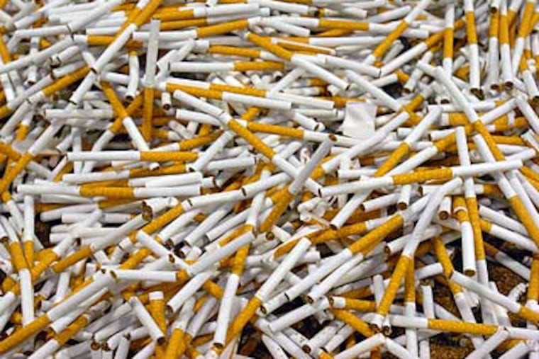 Cigarettes are run through a production line in North Carolina. South Carolina has one of the lowest cigarette taxes. (Jennifer Rotenizer / Associated Press)
