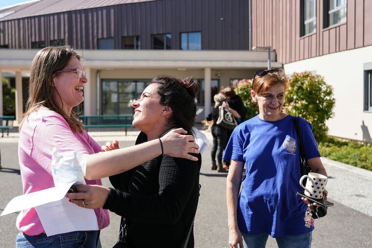 Nurses hug as they leave the Vilanova nursing home in Corbas, near Lyon, central France, on Monday. For 47 days and nights, staff and the 106 residents of the Vilanova nursing home waited out the coronavirus storm together, while the illness killed tens of thousands of people in other homes across Europe, including more than 9,000 in France.
