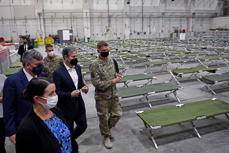 U.S. Secretary of State Antony Blinken, center, tours a processing centre for Afghan evacuees, at al-Udeid Air Base, in Doha, Qatar, Tuesday, Sept. 7, 2021.