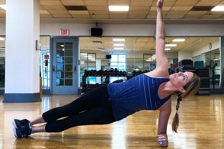 Ashley demonstrates proper side plank form in plank rotations.