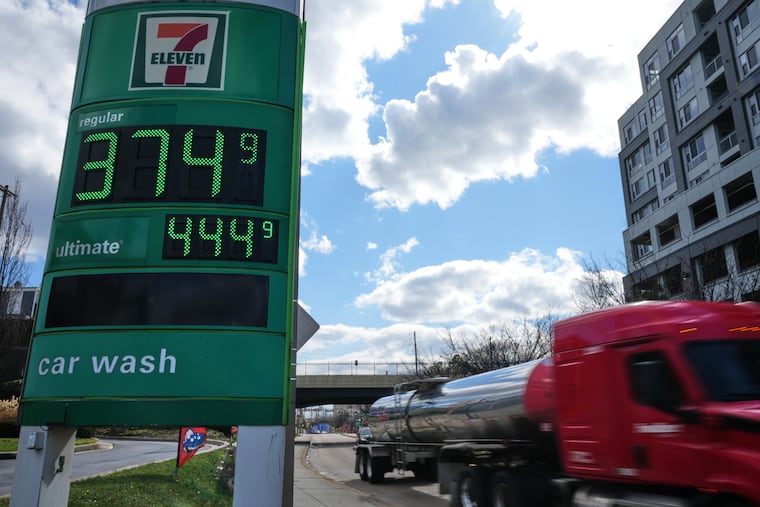 FILE - Fuel prices are displayed on a sign at a gas station as a fuel truck drives by, March 17, 2026, in Baltimore.