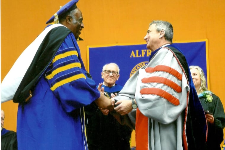 Warren Sutton receives an honorary diploma from Alfred University in 2017.