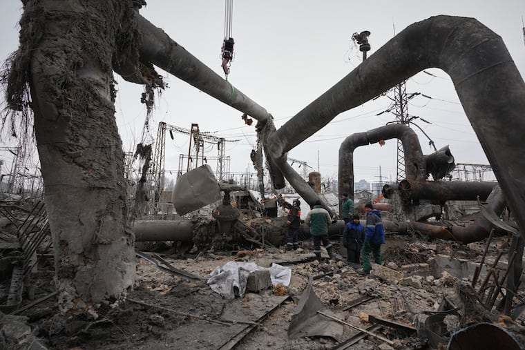 Workers clean up damage at Darnytsia Thermal Power Plant after a Russian attack in Kyiv, Ukraine, on Wednesday, Feb. 4.