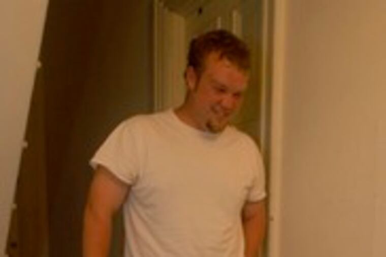 Nick Daley gets ready to descend a stairway littered with his frat brothers' bottles into a room soon to be rescued by DormAid.