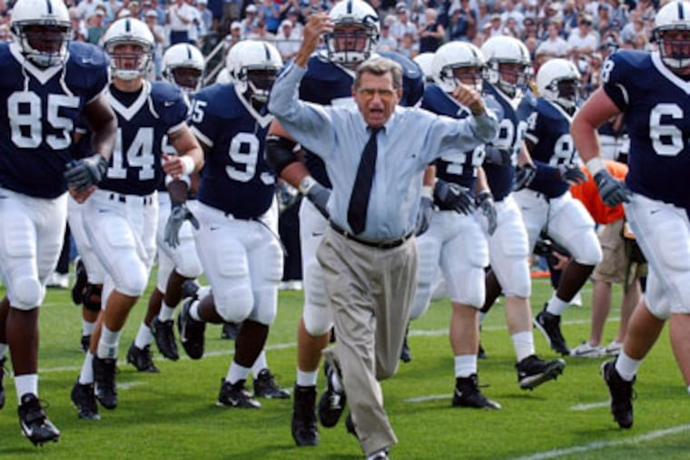 FILE - In this Sept. 4, 2004 file photo, Penn State coach Joe Paterno leads his team onto the field before an NCAA college football game against Akron in State College, Pa. Paterno, the longtime Penn State coach who won more games than anyone else in major college football but was fired amid a child sex abuse scandal that scarred his reputation for winning with integrity, died Sunday, Jan. 22, 2012. He was 85. (AP Photo /Carolyn Kaster, File)