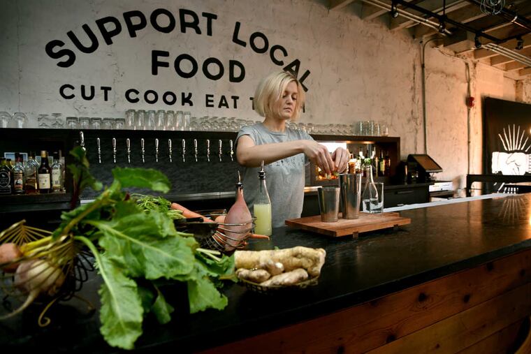 Bartender Amy Hartranft mixes up her variation of a Ramos Gin Fizz with shochu, coconut, and purple carrots at Kensington Quarters February 12, 2017, site of a new monthly popup called the Botanical Series, where both drinks and food are themed around a specific ingredient. This month the focus is on roots/root vegetables.