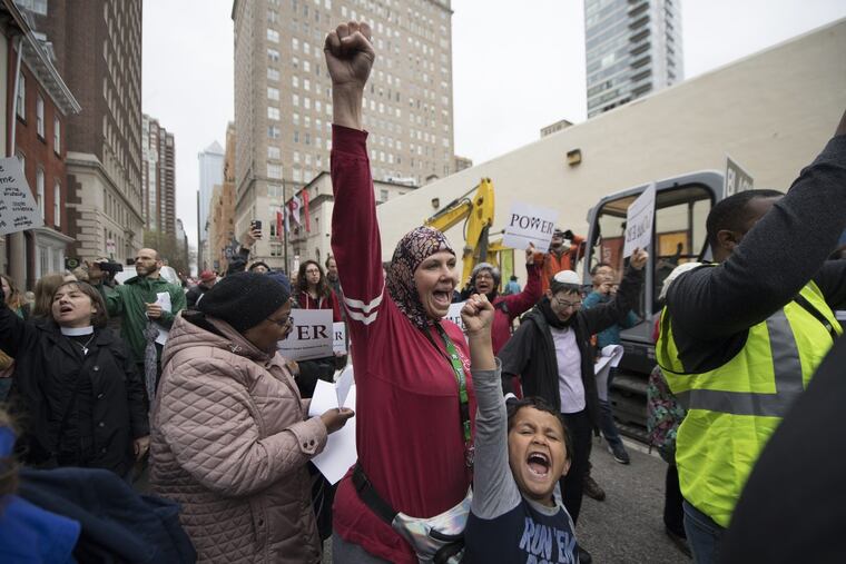 Jennifer Bennetch and her son, Yusuf Williams-Bey, protest outside the Starbucks at 18th and Spruce Streets on Monday.