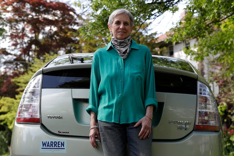 Sara Steele with her 2008 Hybrid Toyota Prius at her West Mount Airy neighborhood on Friday, May 14, 2021. There has been a rapid rise in thefts of catalytic converters, auto parts that reduce emissions and contain precious metals worth more than gold. Thieves have targeted Toyota Prius and other hybrid models.