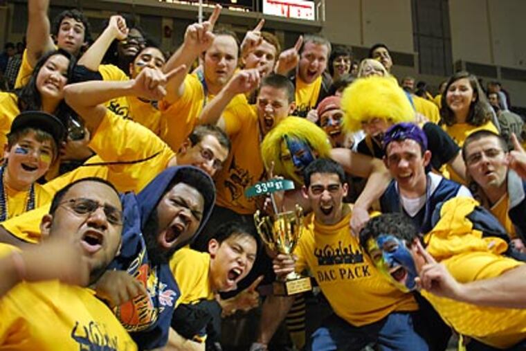 Drexel students celebrate with the "Battle of 33rd Street" Trophy after the Dragons beat Penn. (Jonathan Tannenwald/Philly.com)
