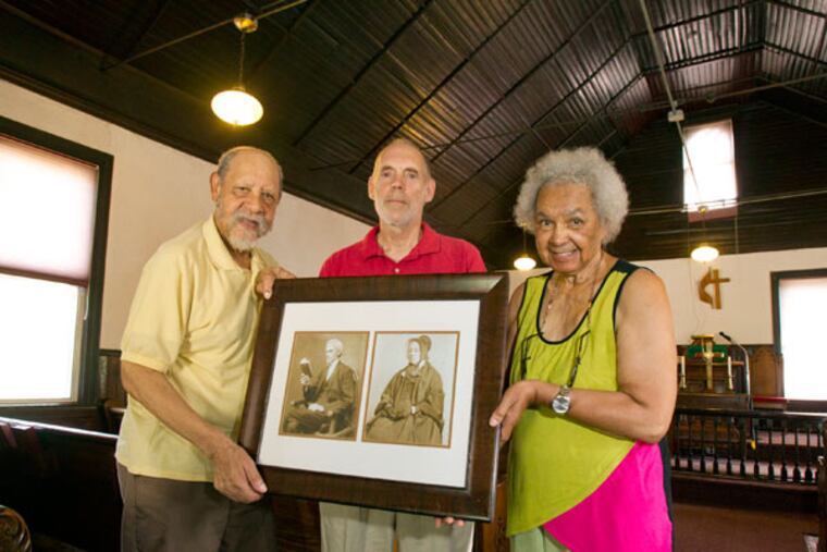 At the Rhoads Temple church, Ray Fussell (left), Chuck Lehman, and the Rev. Alice Cook hold
pictures of Charles and Beulah Rhoads, who founded the church. (CHARLES FOX/Staff Photographer)