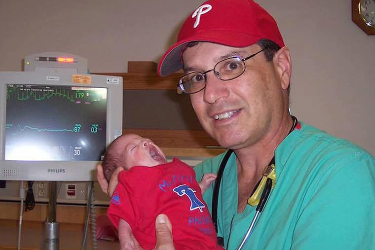 Ralph M. Schrager at the Abington hospital with one of his tiny patients.