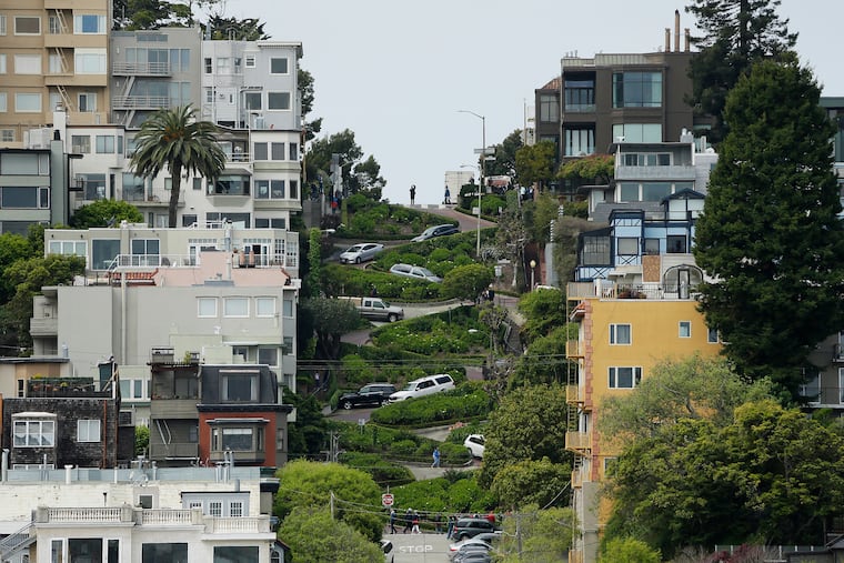 Cars wind their way down Lombard Street in San Francisco, Monday, April 15, 2019. Thousands of tourists may soon have to pay as much as $10 to drive down the world-famous crooked street if a proposal to establish a toll and reservation system becomes law.