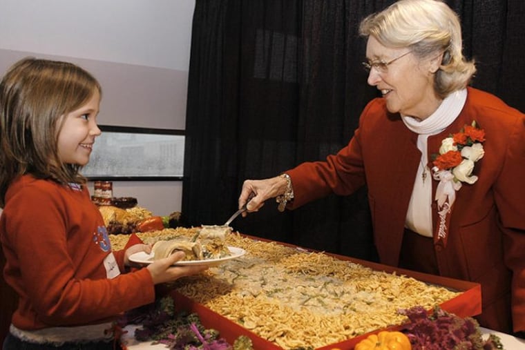 Dorcas Reilly and a small unnamed admirer, with the iconic green bean casserole Mrs. Reilly invented.
