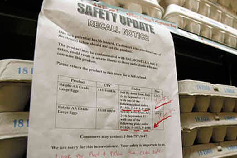 A sign warns customers of the recall of certain lots of eggs sold at a supermarket in Los Angeles. (REED SAXON / Associated Press)