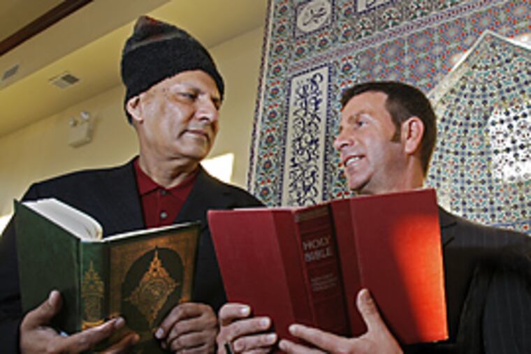 Zia Rahman, left, and Father Joseph Wallace, right discuss the upcoming milestone agreement of understanding and cooperation between their religious communities. (Gerald S. Williams/Inquirer)