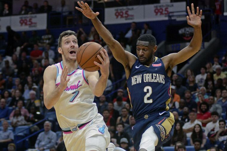 Goran Dragic (7), driving to the basket against Pelicans guard Ian Clark, averages 17.4 points for the Heat.