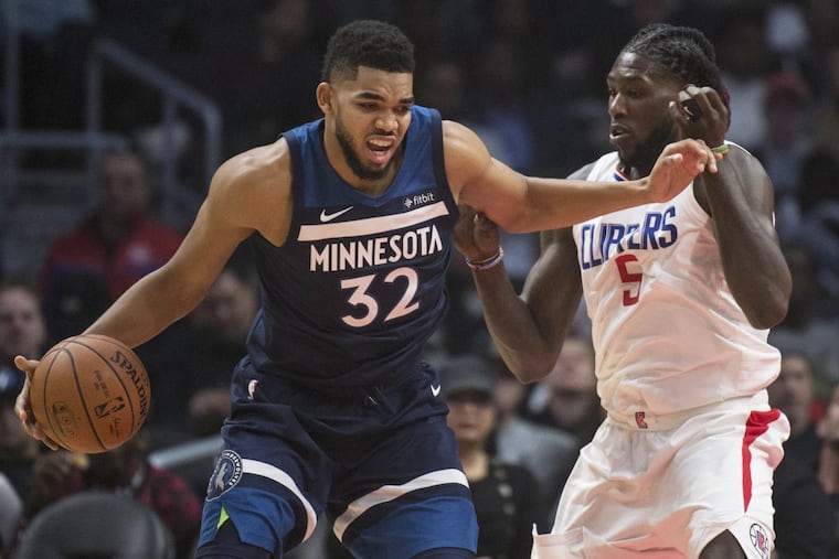 Timberwolves center Karl-Anthony Towns, left, trying to drive past Clippers forward Montrezl Harrell on Dec. 6.