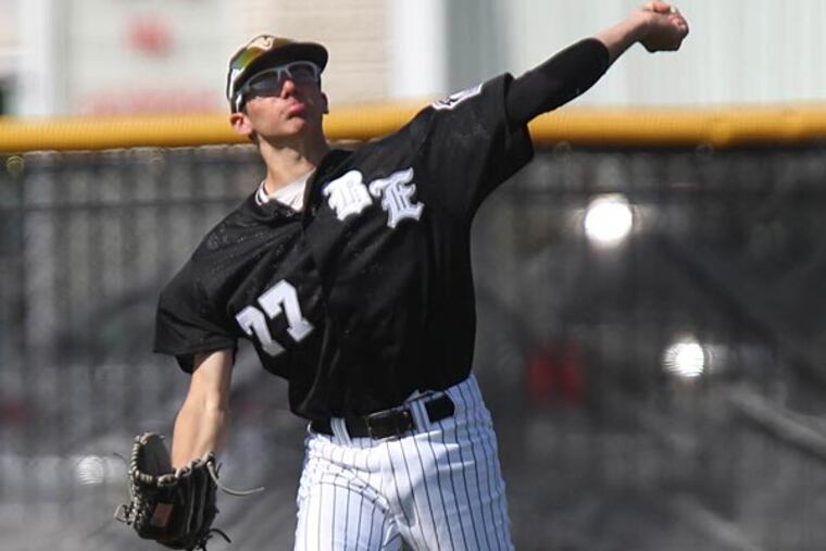 Devin Smeltzer, playing centerfield, winds up to throw a practice ball
back to the dugout during Camden Catholic and Bishop Eustace H.S.
baseball game, April 24, 2013. (David M Warren/ Staff Photographer)