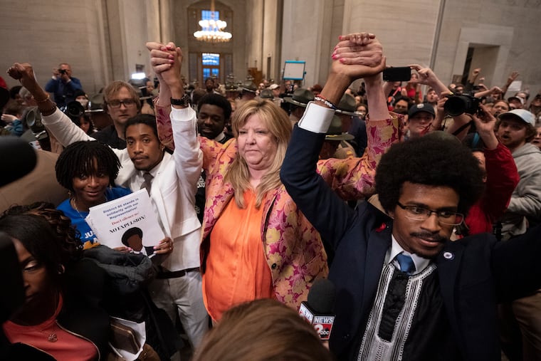 Former Rep. Justin Jones (D., Nashville), Rep. Gloria Johnson (D., Knoxville), and former Rep. Justin Pearson (D., Memphis) raise their hands outside the House chamber after Jones and Pearson were expelled from the legislature Thursday in Nashville, Tenn.