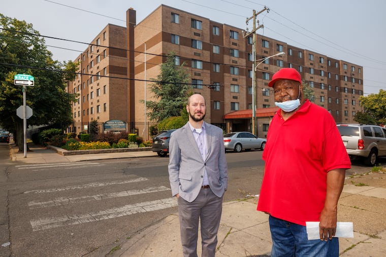 Lawyer Adam Weintraub-Barth with the SeniorLAW Center and resident Earl Dupree, 76, outside Haddington Elderly Housing.