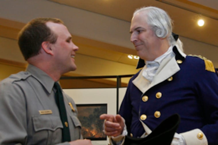 Mike Caldwell (left), Valley Forge superintendent, talks with Gen. Washington (Dean Malissa), during a reception detailing the new program.