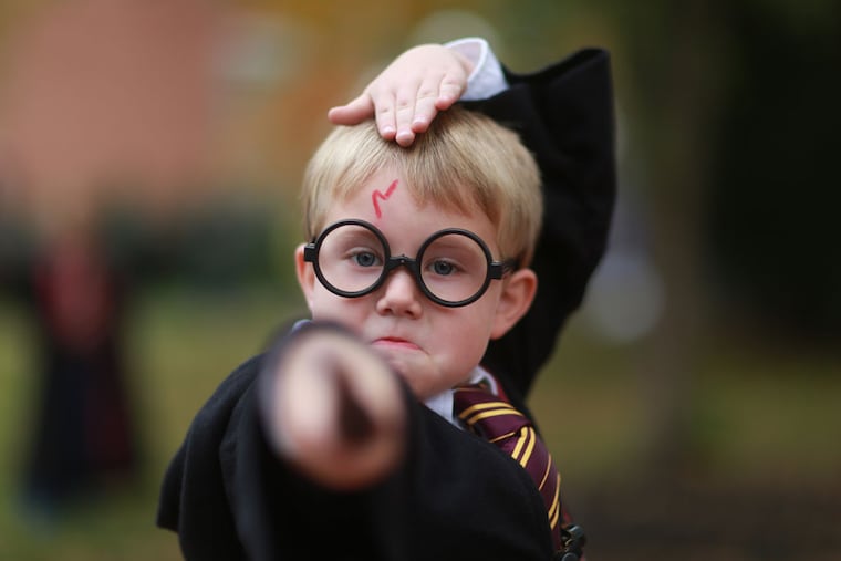 Jamison Walsh, 5, of Port Carbon, Pa., casts a spell in Chestnut Hill at a Harry Potter festival. ( DAVID SWANSON / Staff Photographer )