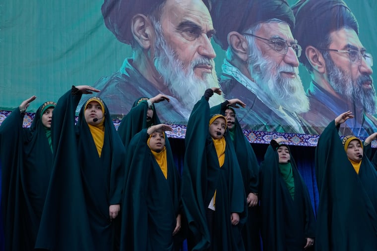 Girls sing a song as they show the movement of missiles with their hands next to the portraits of the late Iranian revolutionary founder Ayatollah Khomeini, left, late Supreme Leader Ayatollah Ali Khamenei, center, and Supreme Leader Ayatollah Mojtaba Khamenei, in a state-organised rally celebrating the birthday of Imam Reza, the 8th Shiite Muslims' Imam, and supporting the supreme leader, in Tehran, Iran, Wednesday, April 29, 2026.