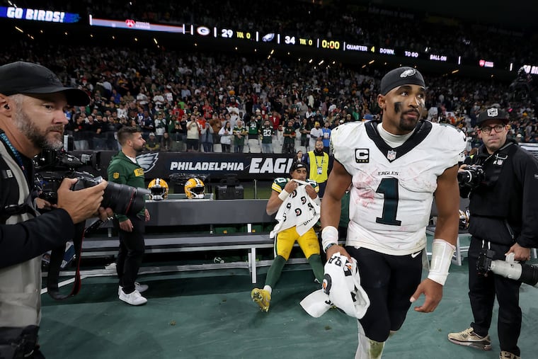Eagles quarterback Jalen Hurts (right) jogs off after interacting with Green Bay Packers quarterback Jordan Love on the bench after the season opener against the Green Bay Packers at Corinthians Arena in São Paulo, Brazil, Friday, Sept. 6, 2024. Love was injured in the game.