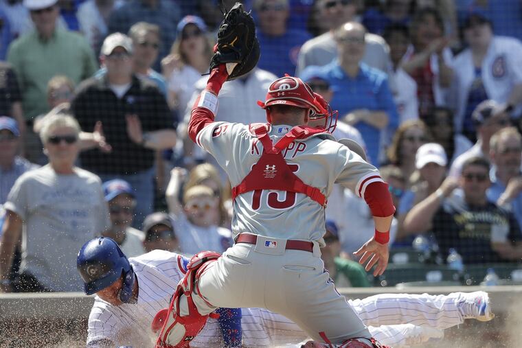 Phillies catcher Andrew Knapp tries to lay the tag down on Albert Almora Jr. in the fifth inning of the Phillies 4-3 loss to the Cubs. The play was overturned by video review with Knapp called for catcher interference.